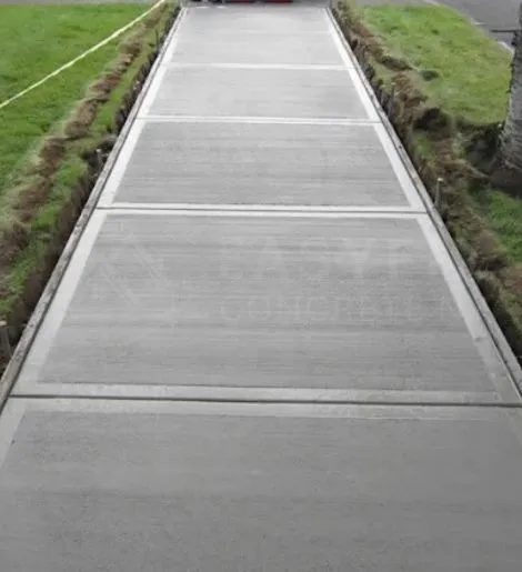 New concrete walkway installation between lawns