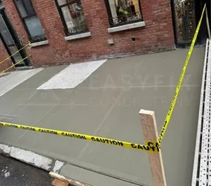 New sidewalk in front of a Harlem brownstone
